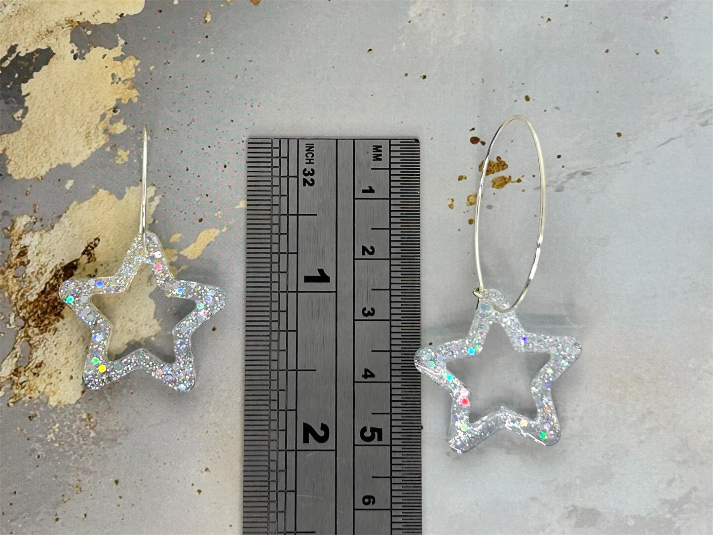 Handmade Star Resin Earrings with silver holographic glitter, silver plated hoops, different hoop sizes.