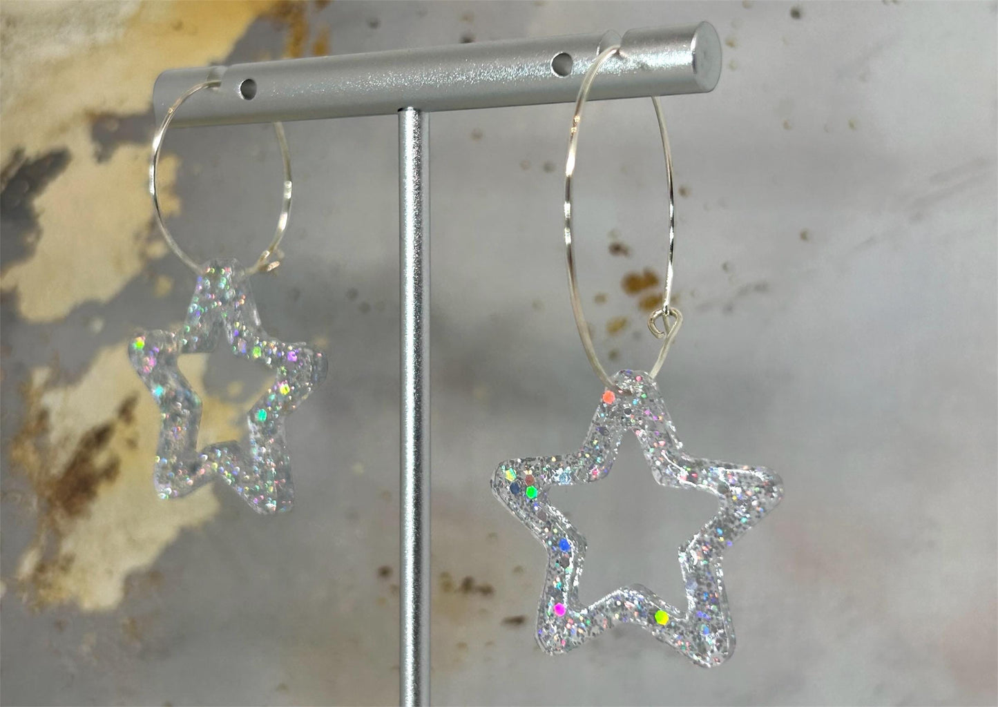 Handmade Star Resin Earrings with silver holographic glitter, silver plated hoops, different hoop sizes.