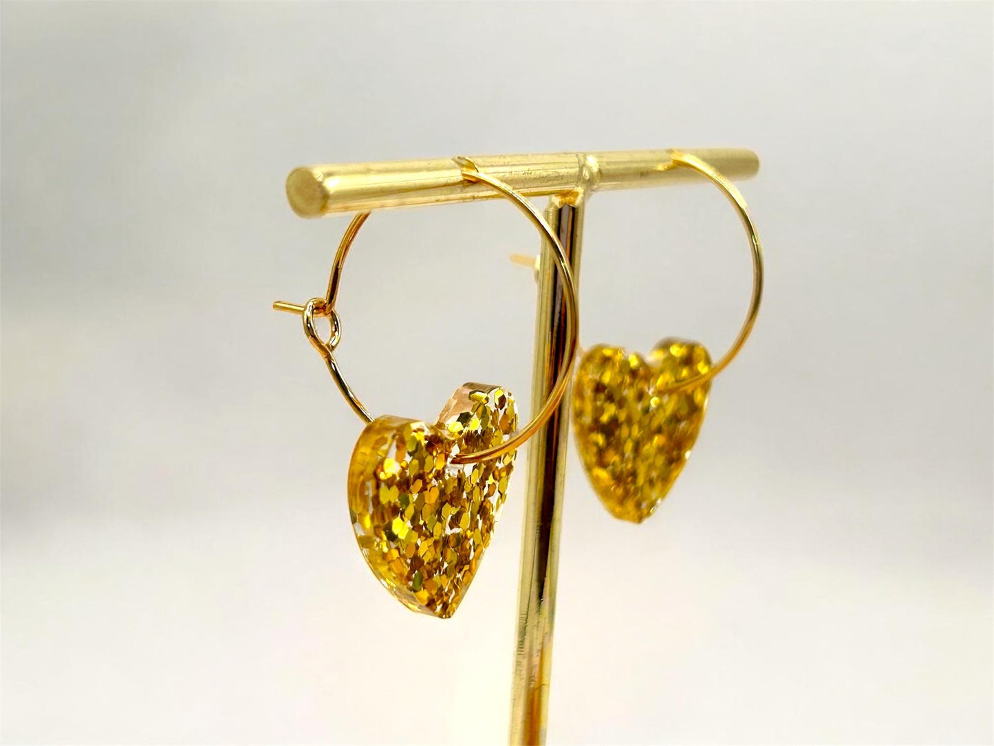 Handmade Heart Resin Charm Earrings with Gold Glitter on Gold Plated Hoops. Choice of size: large or small. Perfect gift or treat yourself!
