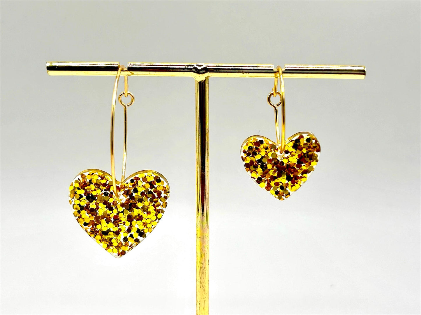Handmade Heart Resin Charm Earrings with Gold Glitter on Gold Plated Hoops. Choice of size: large or small. Perfect gift or treat yourself!