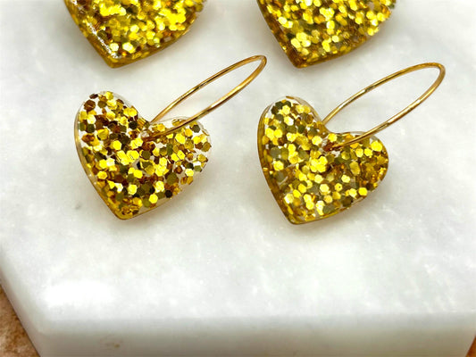Handmade Heart Resin Charm Earrings with Gold Glitter on Gold Plated Hoops. Choice of size: large or small. Perfect gift or treat yourself!
