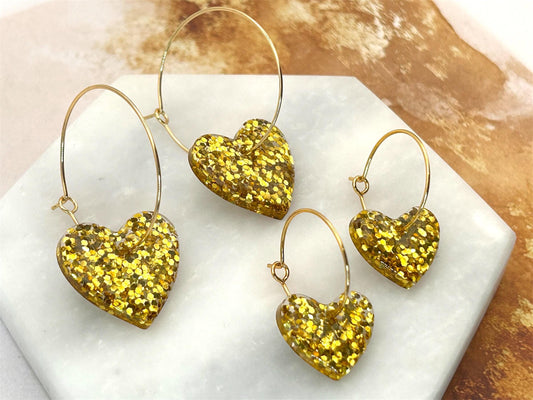 Handmade Heart Resin Charm Earrings with Gold Glitter on Gold Plated Hoops. Choice of size: large or small. Perfect gift or treat yourself!